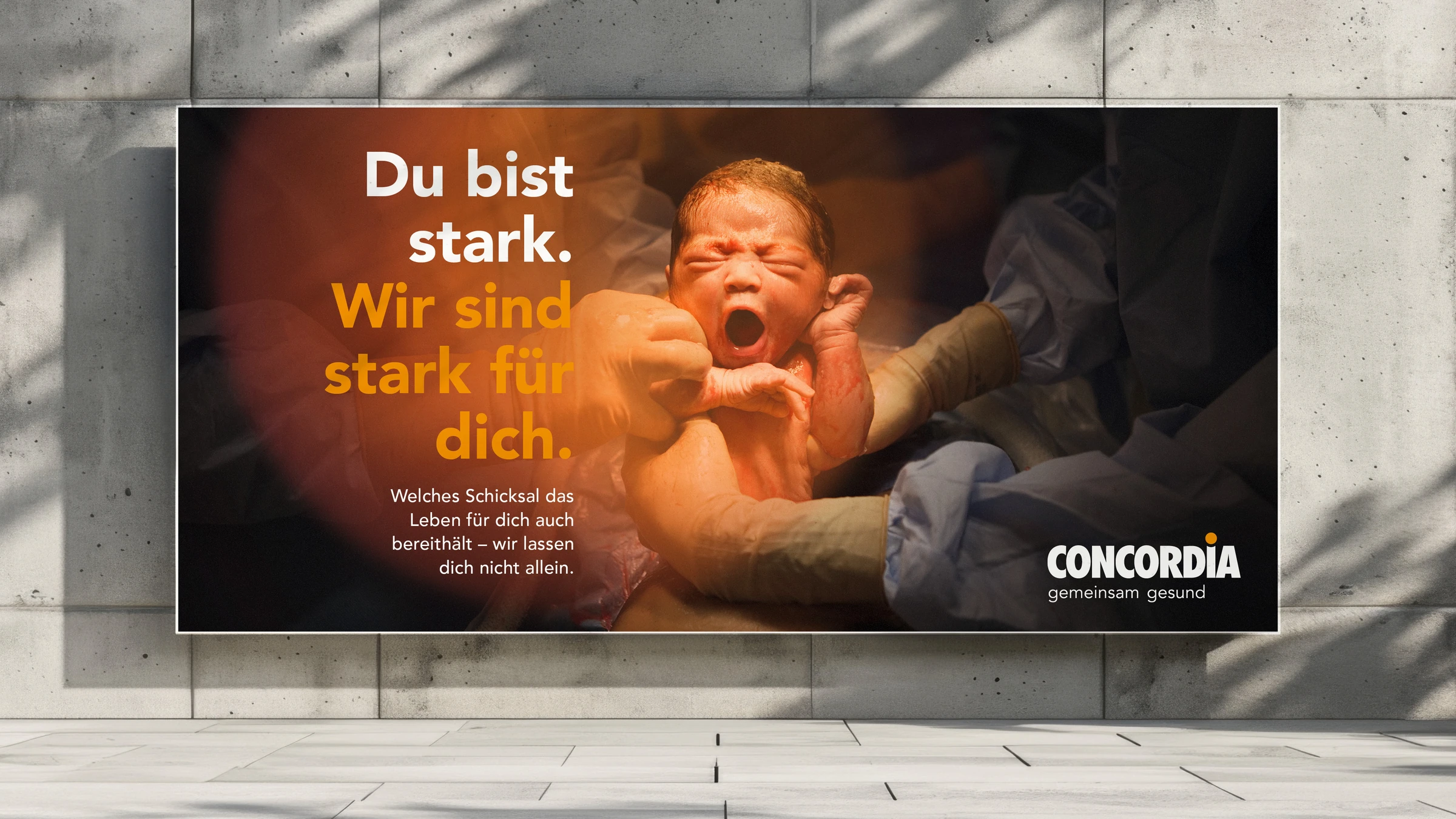 Affiche CONCORDIA « Du bist stark » avec un nouveau-né et un halo orange.