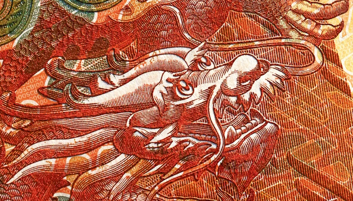 Détail d’un dragon gravé en rouge et orange dans une composition SICPA.