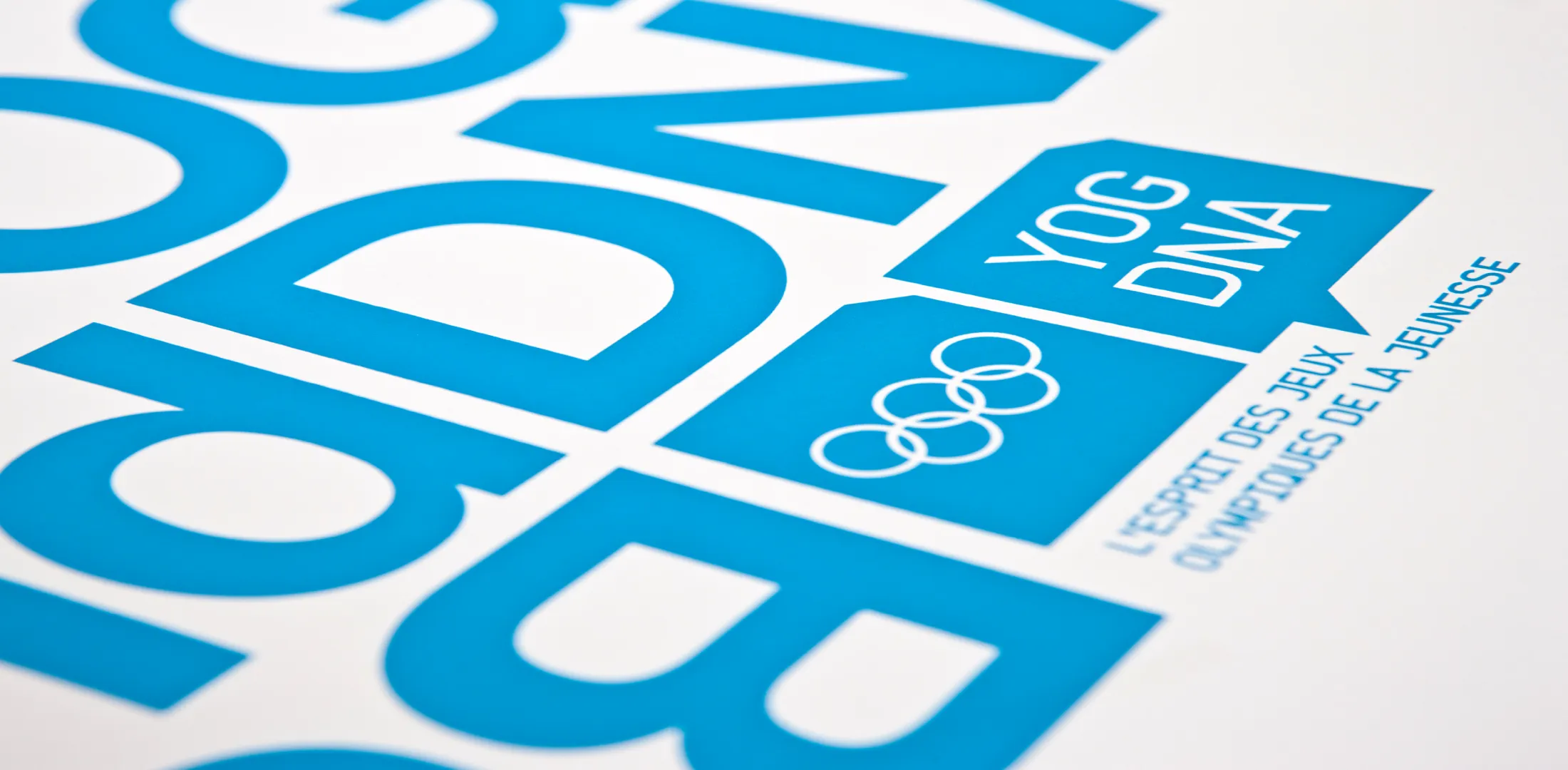 Détail bleu de la couverture du brand book YOG DNA et de sa typographie diagonale.